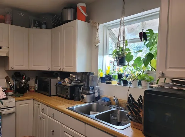 a kitchen with a sink a counter space and a window