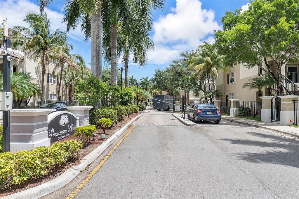 6020 West Sample Road, Unit 103 Coral Springs, FL 33067 - Photo 18 of 20 a view of a street with a cars parked