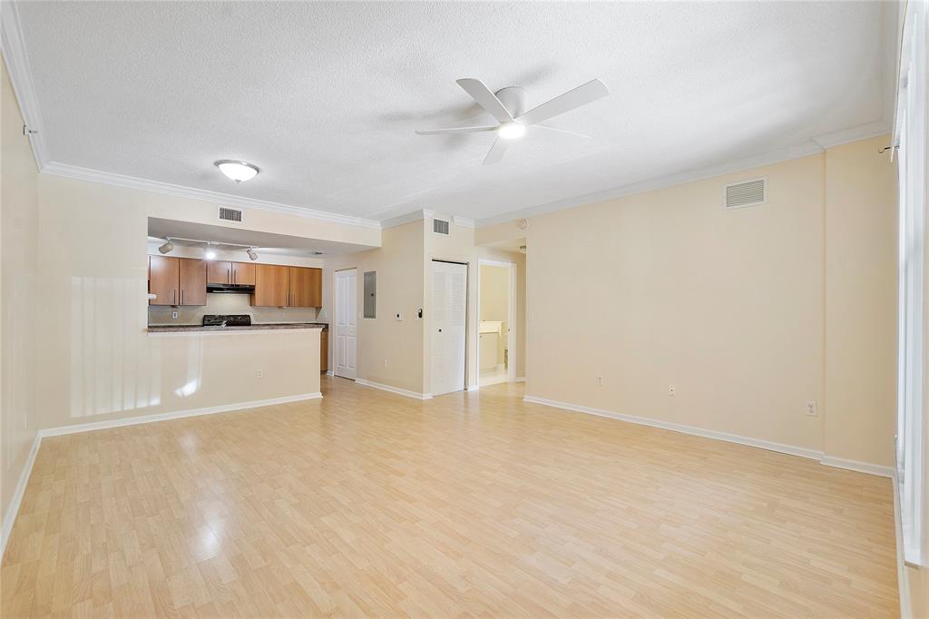 6020 West Sample Road, Unit 103 Coral Springs, FL 33067 - Photo 4 of 20 an empty room with a empty space and windows