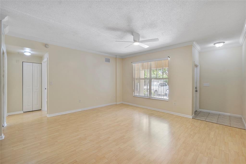 6020 West Sample Road, Unit 103 Coral Springs, FL 33067 - Photo 5 of 20 a view of an empty room with a window