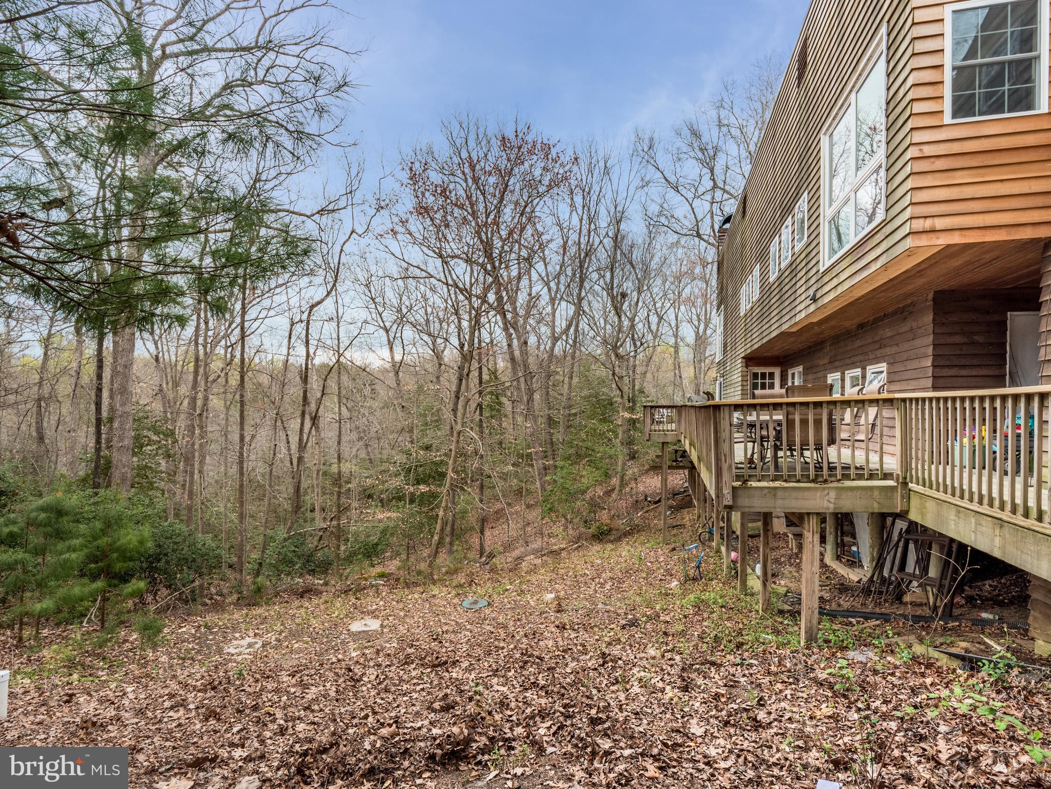 12466 Dalton Trail Lusby, MD 20657 - Photo 15 of 74 a balcony with table and chairs and wooden fence