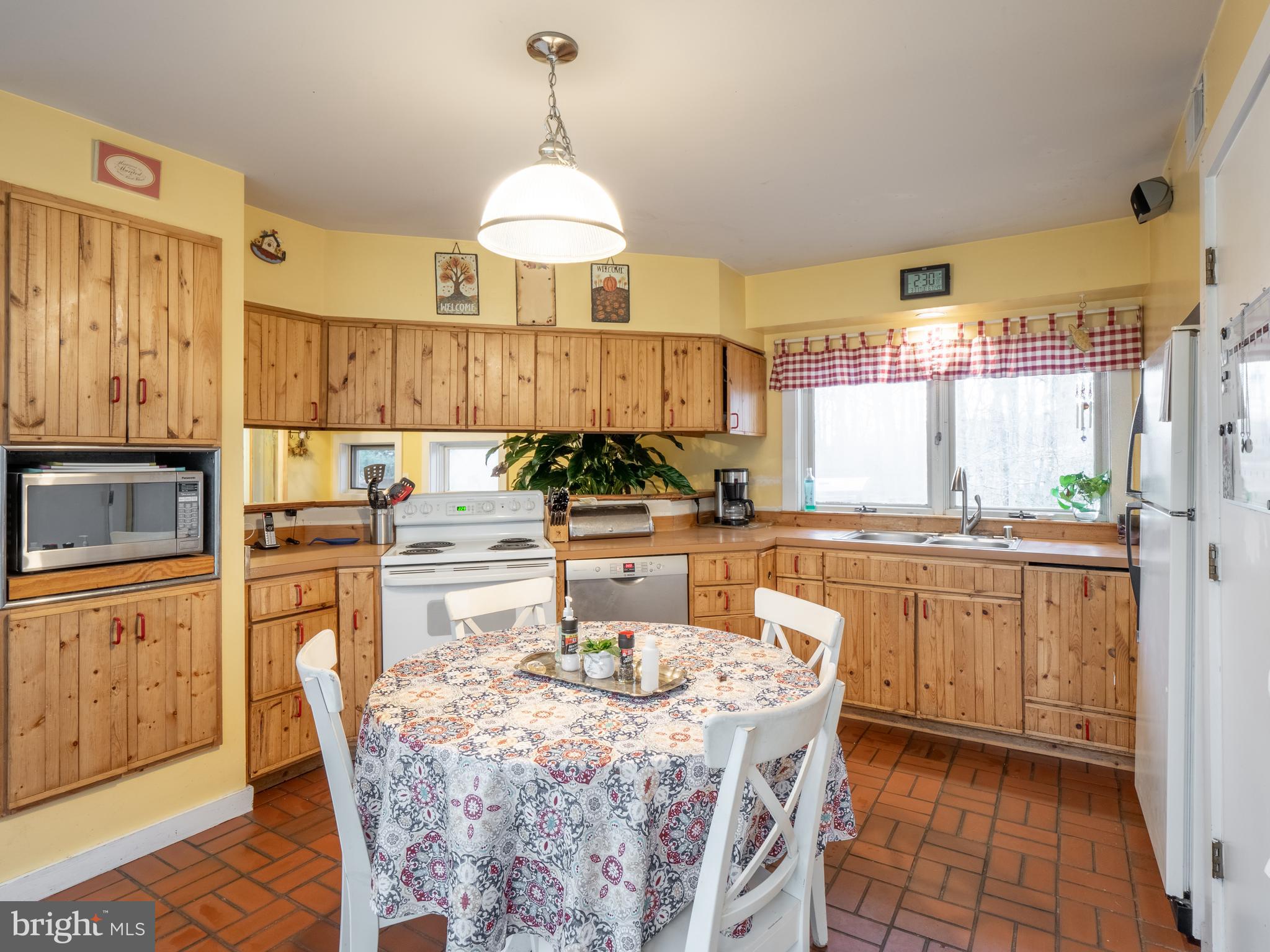 12466 Dalton Trail Lusby, MD 20657 - Photo 19 of 74 a kitchen with stainless steel appliances granite countertop a stove a sink a refrigerator and a wooden cabinets