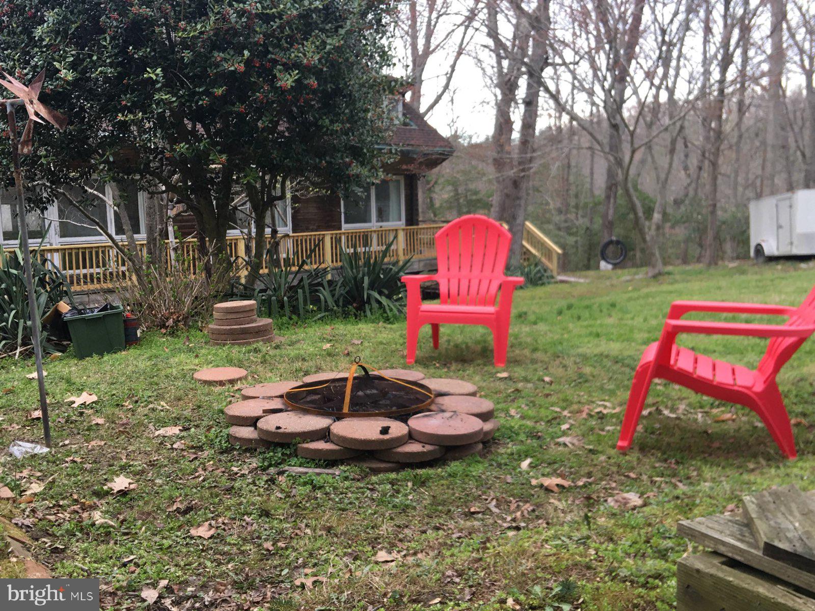 12466 Dalton Trail Lusby, MD 20657 - Photo 43 of 74 a backyard of a house with yard fire pit and outdoor seating