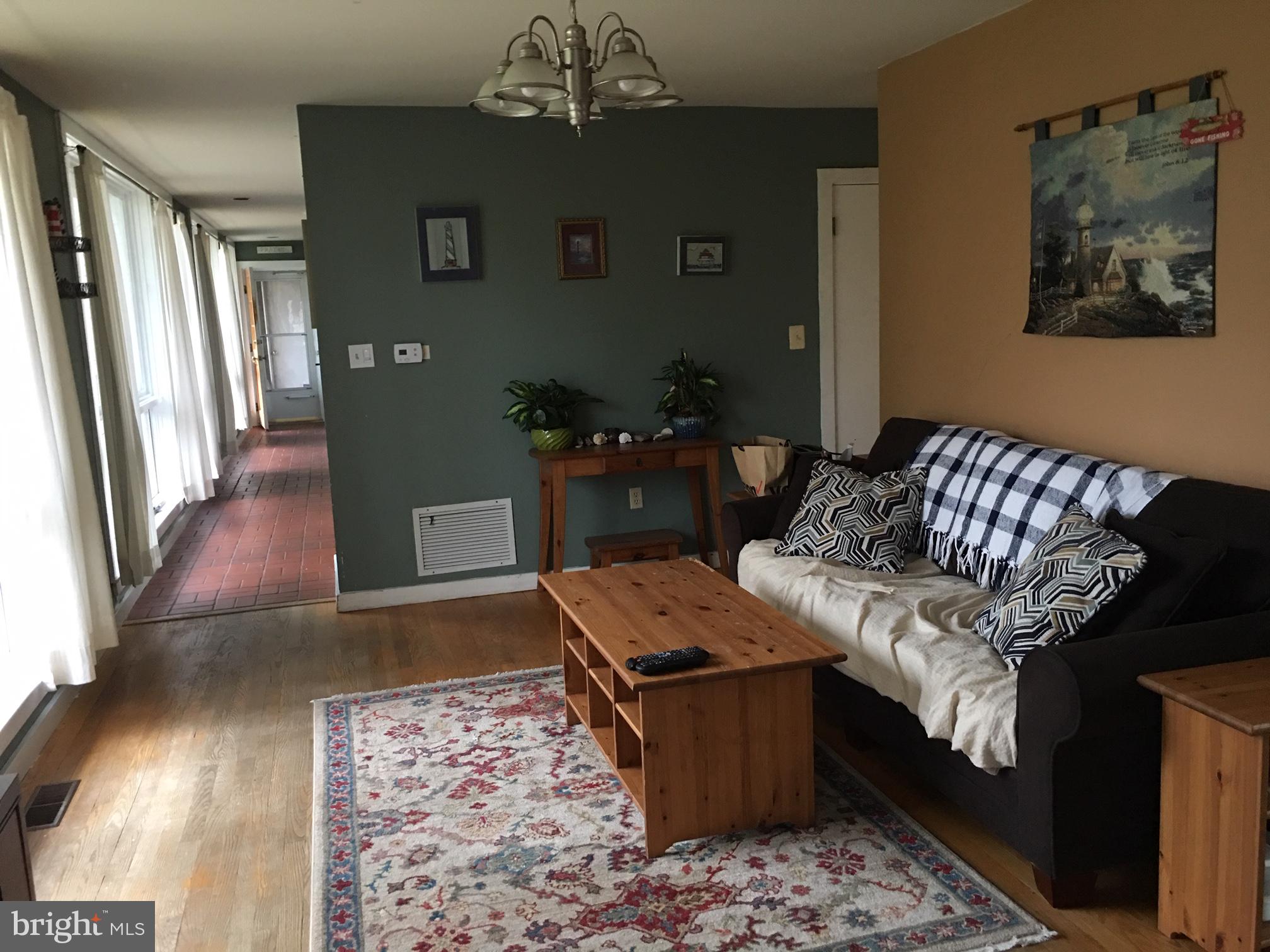 12466 Dalton Trail Lusby, MD 20657 - Photo 52 of 74 a living room with furniture and a chandelier