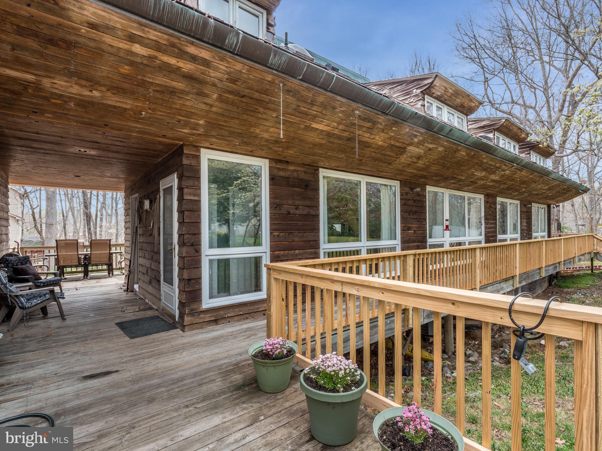 12466 Dalton Trail Lusby, MD 20657 - Photo 6 of 74 a view of a patio with table and chairs and wooden floor