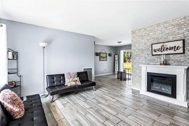 a view of a livingroom with an empty space and a fireplace