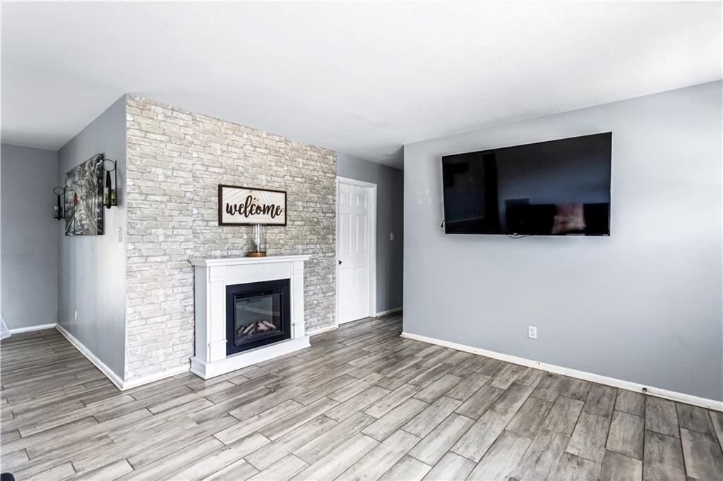 1646 Flicker Road Hampton, GA 30228 - Photo 12 of 38 a view of a livingroom with an empty space and a fireplace