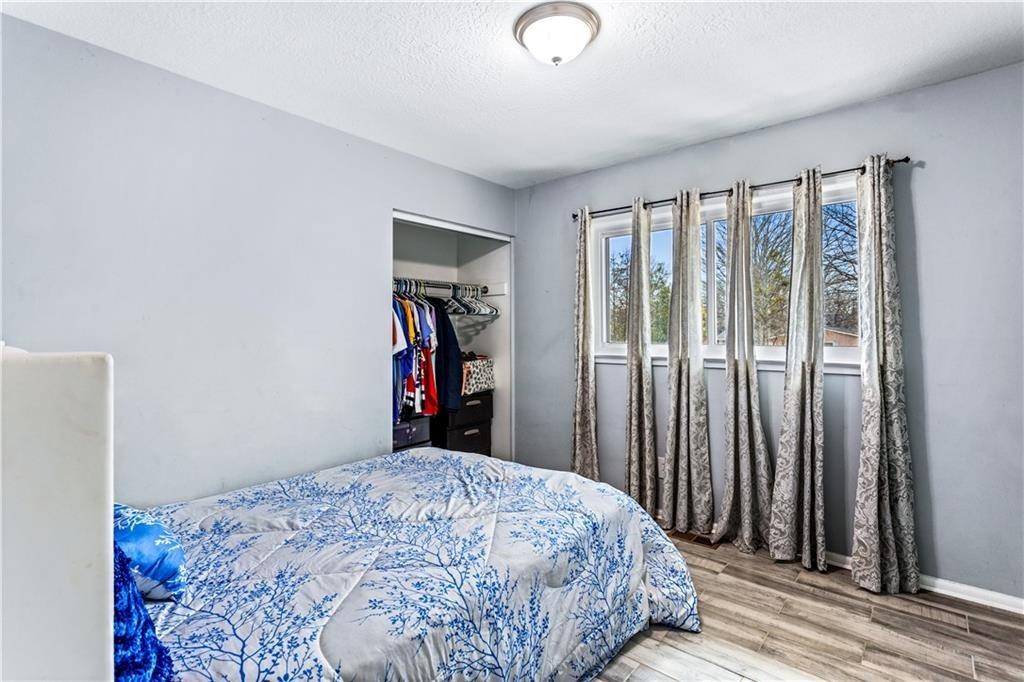 1646 Flicker Road Hampton, GA 30228 - Photo 27 of 38 a bed sitting in a bedroom next to a window and a chandelier