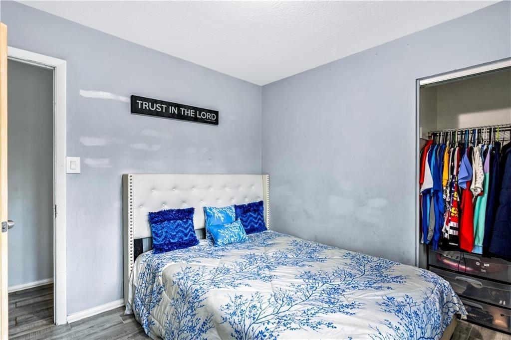 1646 Flicker Road Hampton, GA 30228 - Photo 28 of 38 a bedroom with a bed and a large mirror