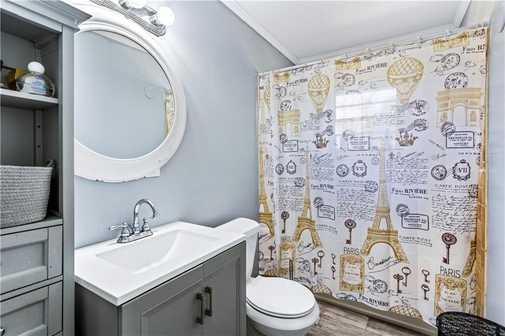 1646 Flicker Road Hampton, GA 30228 - Photo 29 of 38 a bathroom with a toilet sink and mirror