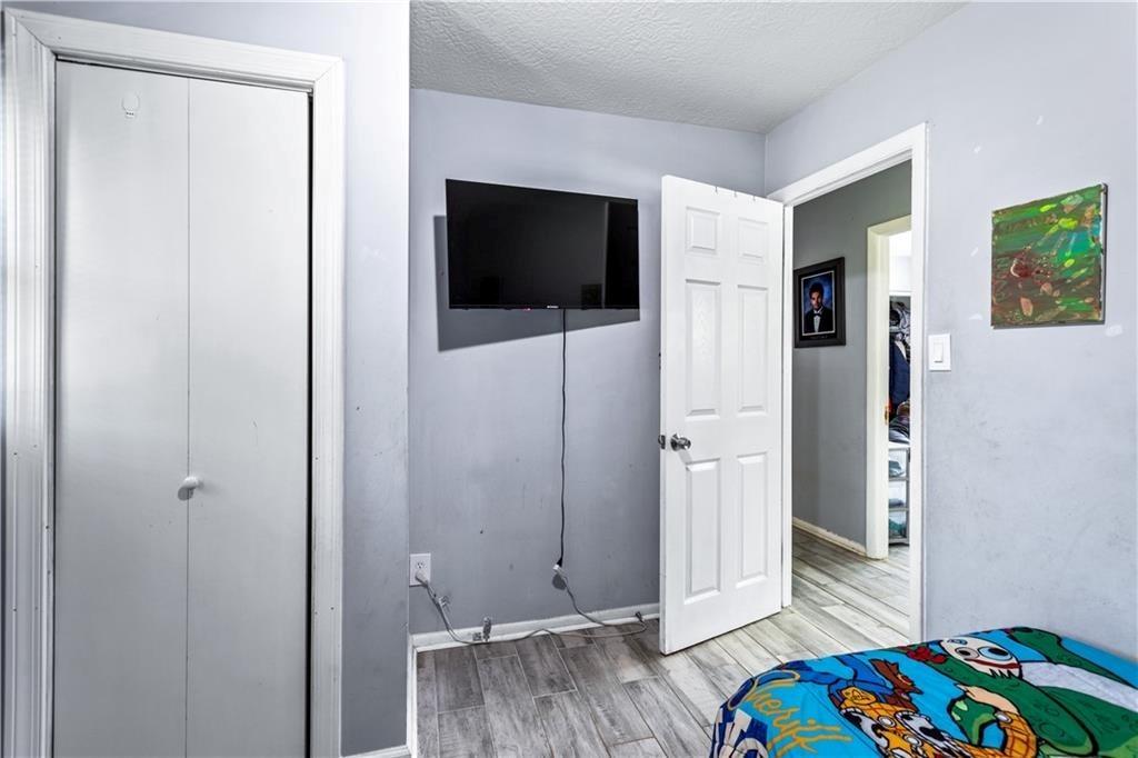 1646 Flicker Road Hampton, GA 30228 - Photo 32 of 38 a bedroom with a bed and wooden floor