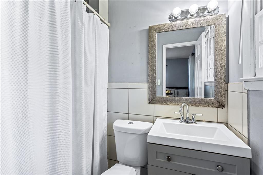 1646 Flicker Road Hampton, GA 30228 - Photo 34 of 38 a bathroom with a sink and a mirror