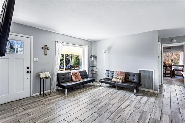 a living room with furniture and a fireplace