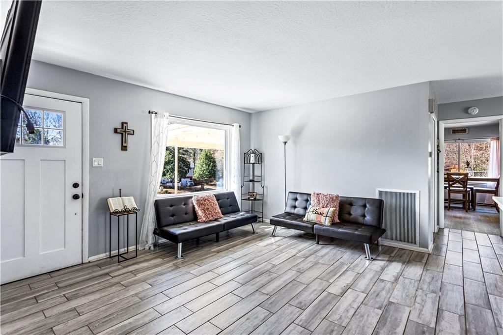 1646 Flicker Road Hampton, GA 30228 - Photo 10 of 38 a living room with furniture and a wooden floor