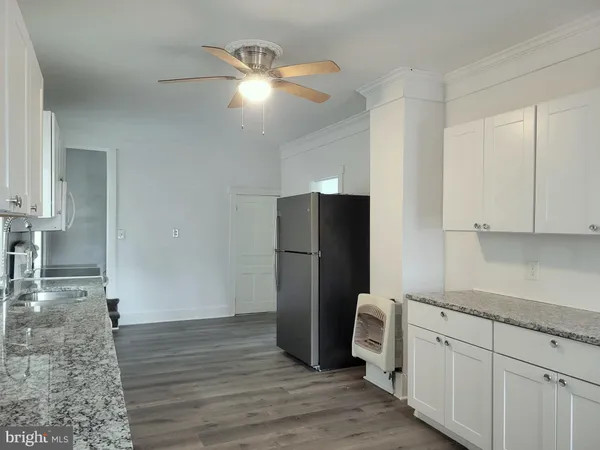 a kitchen with stainless steel appliances granite countertop a refrigerator and a stove