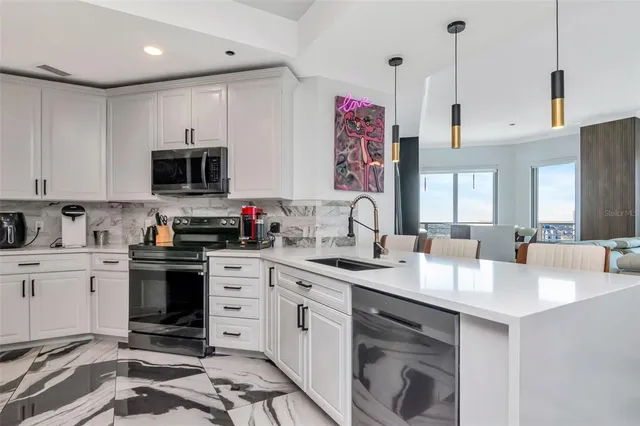 a kitchen with stainless steel appliances granite countertop a stove and a sink