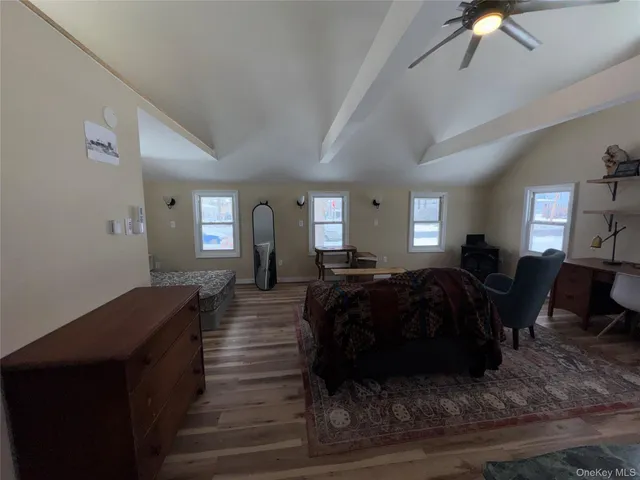 a living room with furniture a lamp a rug and a window