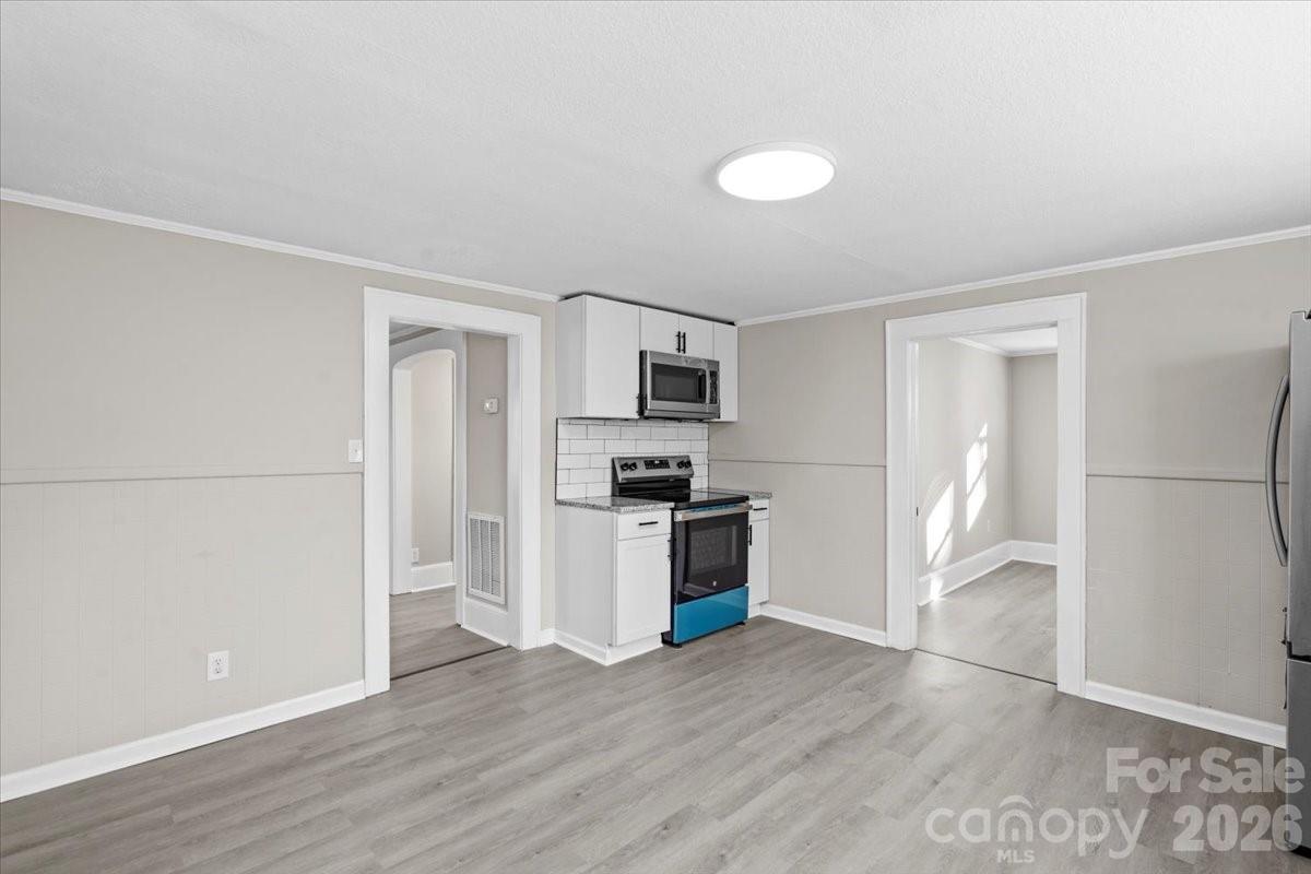 2217 Old Shelby Road Hickory, NC 28602 - Photo 12 of 20 a kitchen with granite countertop a refrigerator and a stove top oven