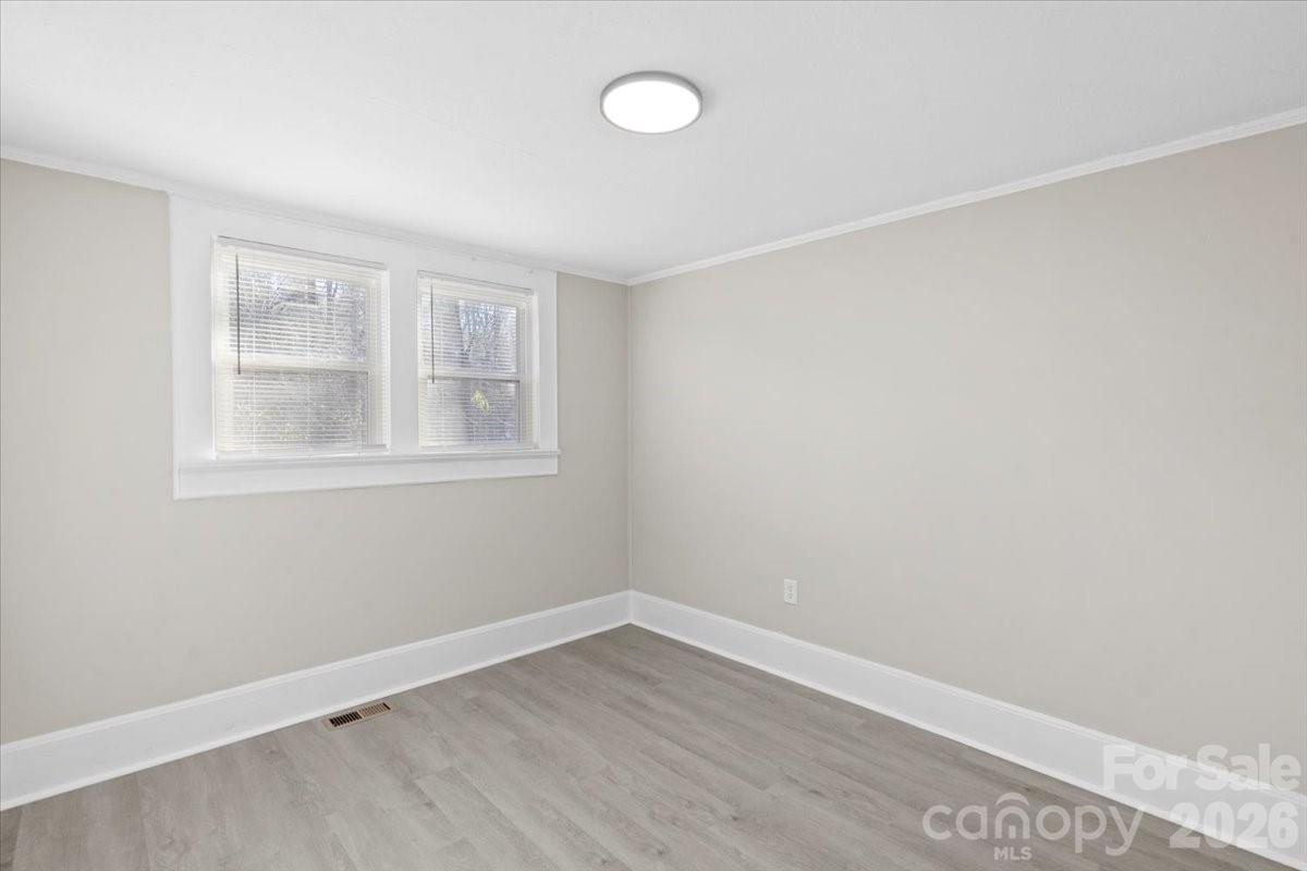 2217 Old Shelby Road Hickory, NC 28602 - Photo 13 of 20 an empty room with wooden floor and windows