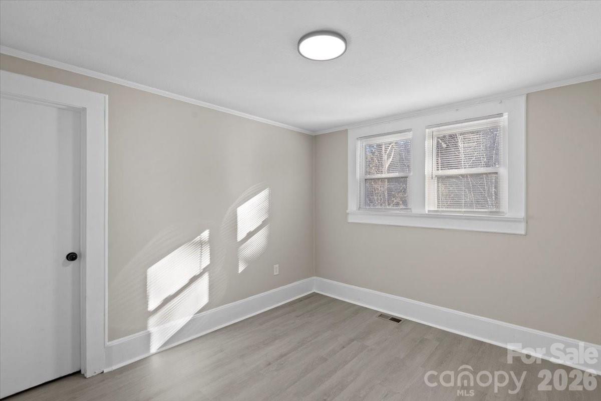 2217 Old Shelby Road Hickory, NC 28602 - Photo 15 of 20 a view of an empty room with a window and wooden floor