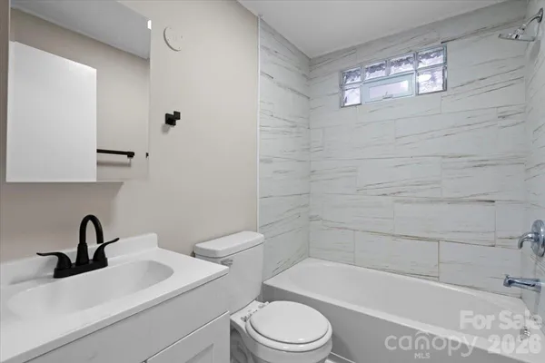 a bathroom with a toilet a sink and bathtub