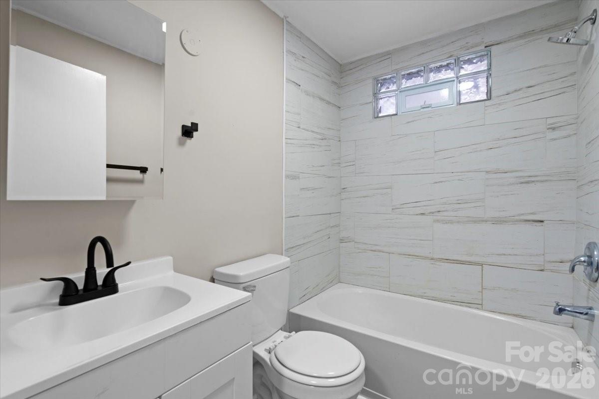 2217 Old Shelby Road Hickory, NC 28602 - Photo 17 of 20 a bathroom with a toilet a sink and bathtub
