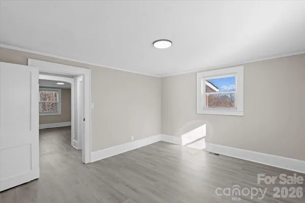 a view of room with window and wooden floor