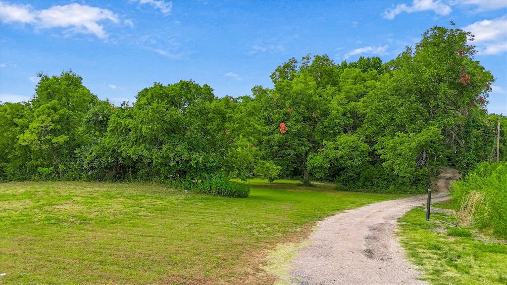 548 Dalrock Road Rowlett, TX 75089 - Photo 4 of 19 This road take you all the way to the back of the lot.