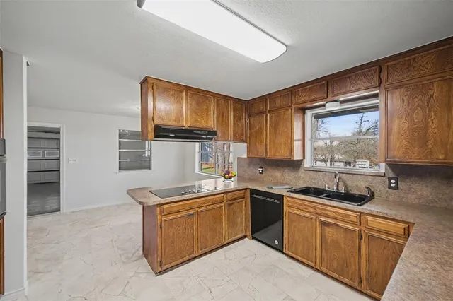 a kitchen that has a sink and a stove