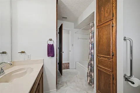 a bathroom with a tub sink and mirror