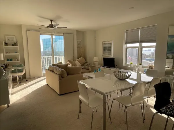 a living room with furniture wooden floor and a view of kitchen