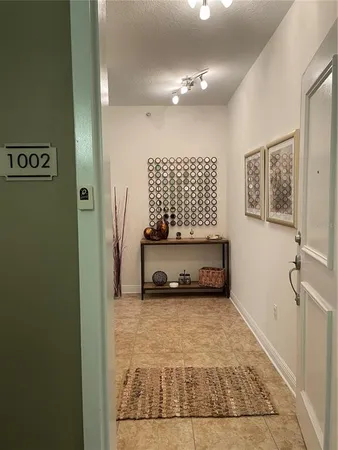 a view of a hallway with entryway door