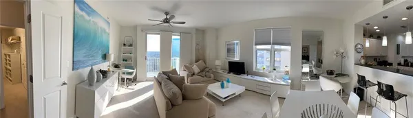 a living room with furniture and a large mirror