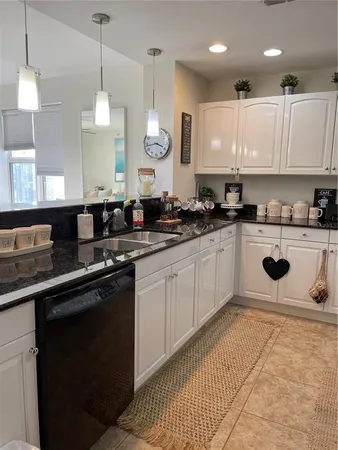 a kitchen with a sink a counter top space cabinets and stainless steel appliances