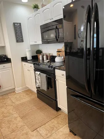 a kitchen with stainless steel appliances granite countertop a stove a microwave and a refrigerator