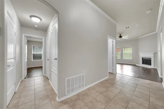 a view of a big room with wooden floor and windows