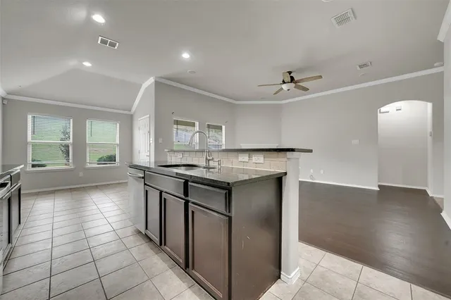 a kitchen with stainless steel appliances granite countertop a sink stove and cabinets