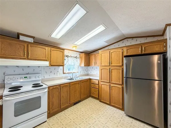 a kitchen with a sink stove and cabinets