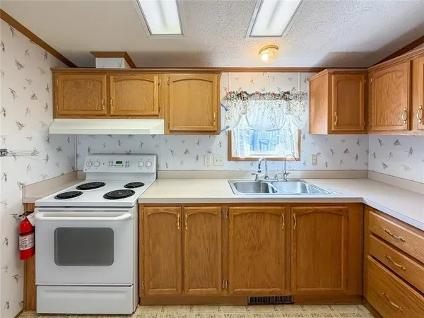 a kitchen with stainless steel appliances granite countertop a stove and a refrigerator