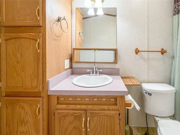 a white toilet sitting next to a bath tub and shower