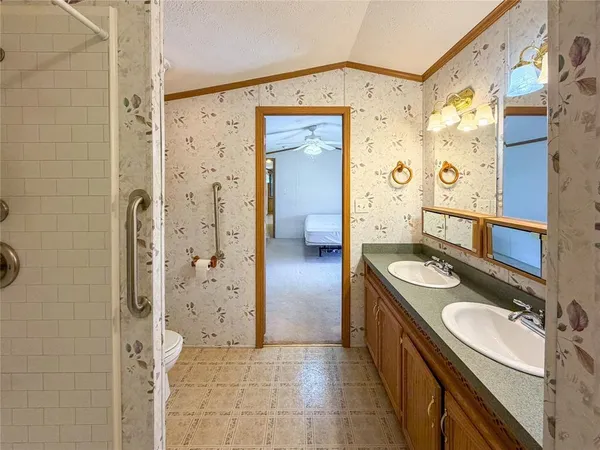 a bathroom with a toilet and a shower