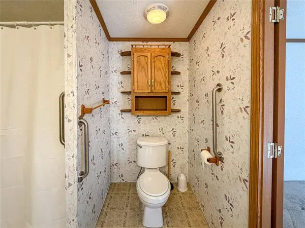a bathroom with a shower toilet and sink