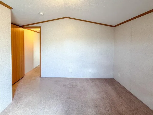 an empty room with closet and wooden floor