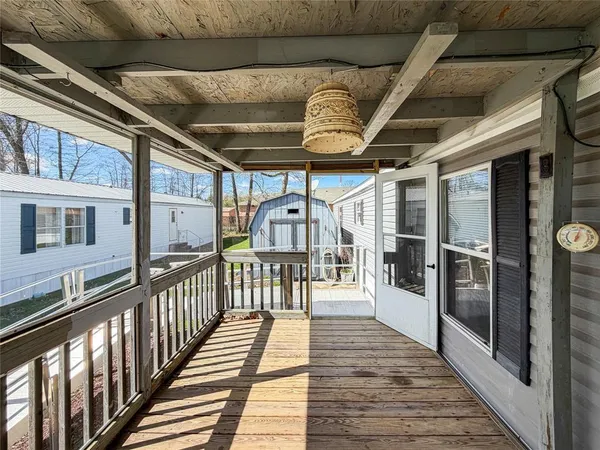 a view of a porch with wooden floor