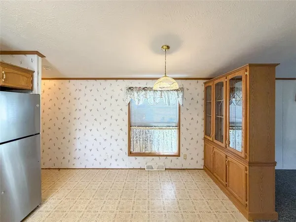 a kitchen with a stove a sink dishwasher a refrigerator and a stove top oven