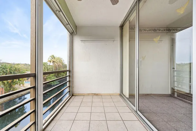 a view of a room with wooden floor and windows