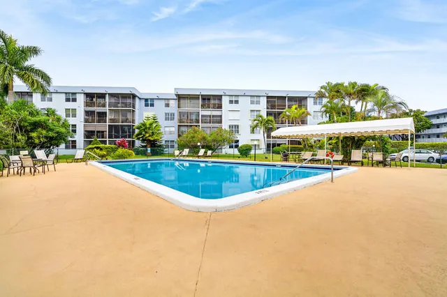 a view of swimming pool with outdoor seating