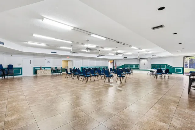 a room with lots of furniture and a dining table with kitchen view