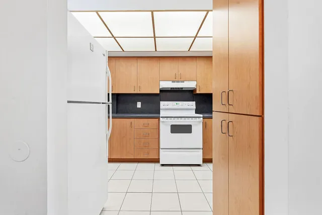 a kitchen with a white cabinets and white appliances