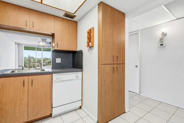 a kitchen with stainless steel appliances granite countertop a refrigerator and a stove